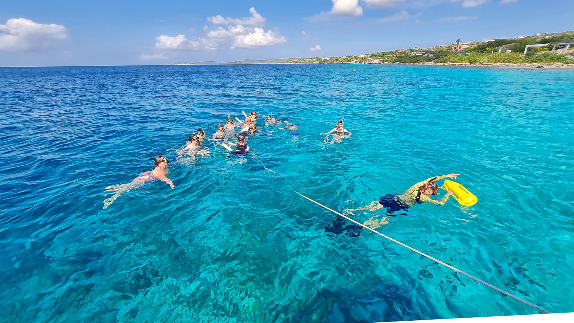 Snorkelers floating over turquoise reef