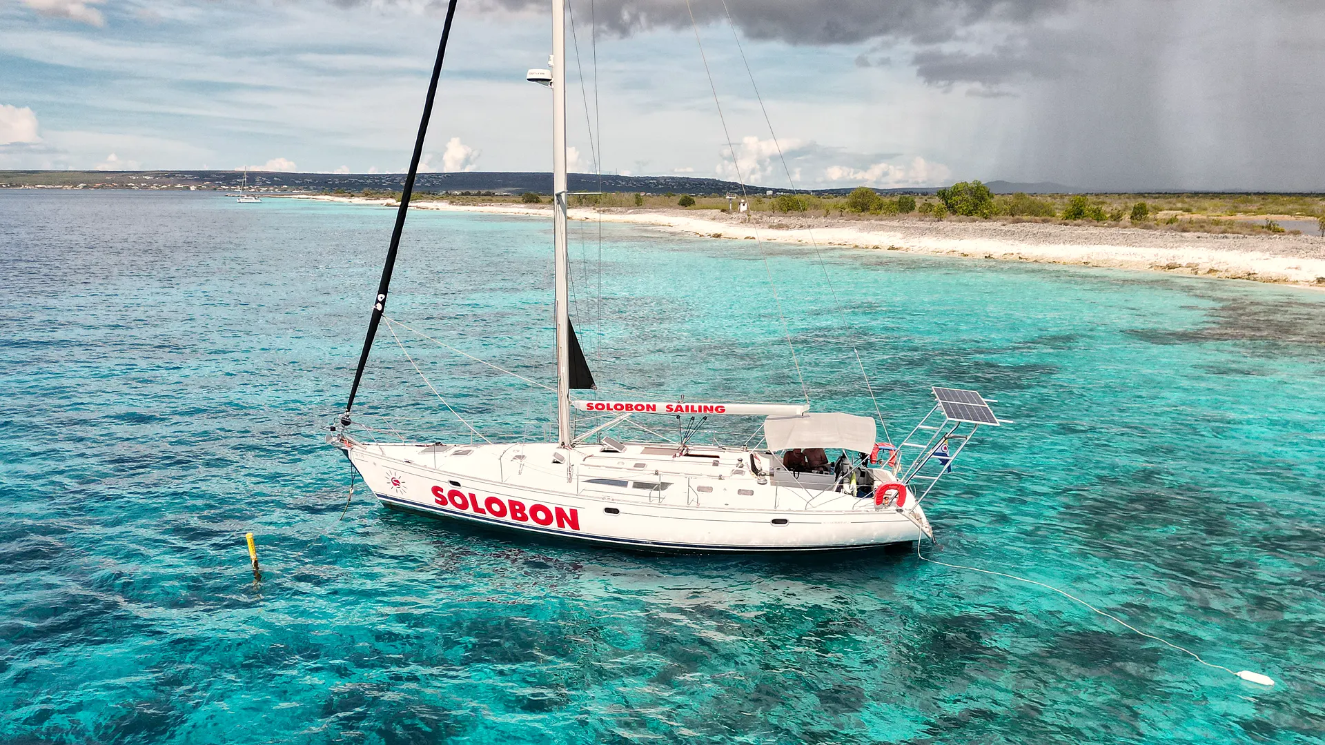 Phoenix moored over clear turquoise water off the Bonaire coast