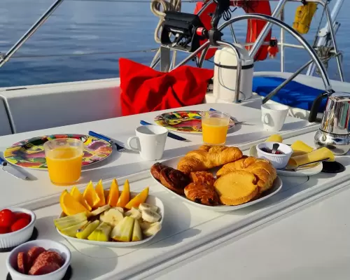 Breakfast of fruit, croissants and juice laid out in the cockpit