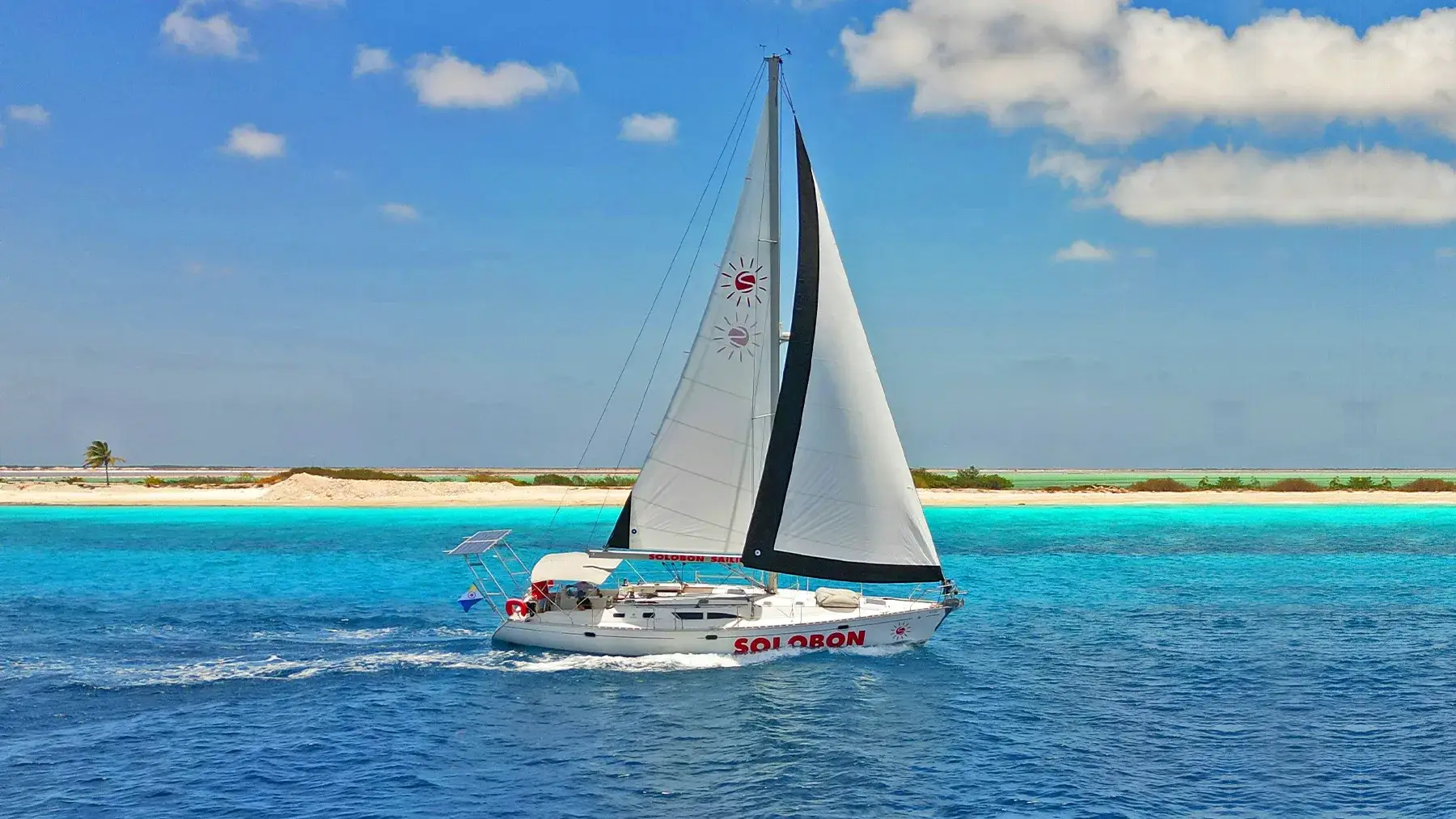 Phoenix sailing past the turquoise shallows of Klein Bonaire